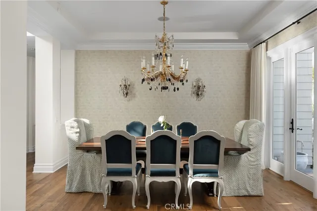a view of a dining room with furniture and chandelier