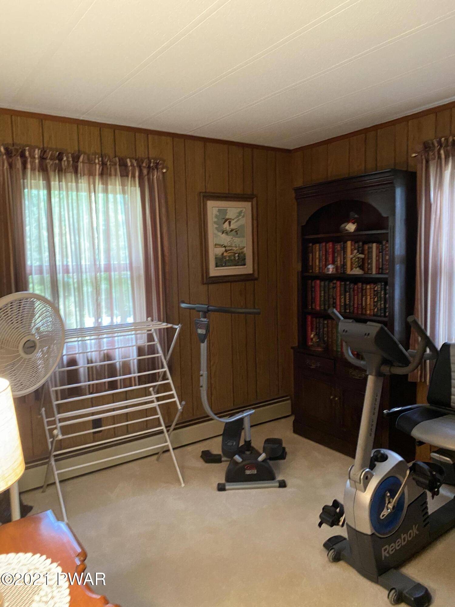 125 Maple Ridge Drive Hawley, PA 18428 - Photo 23 of 49 a room with gym equipment and a large window