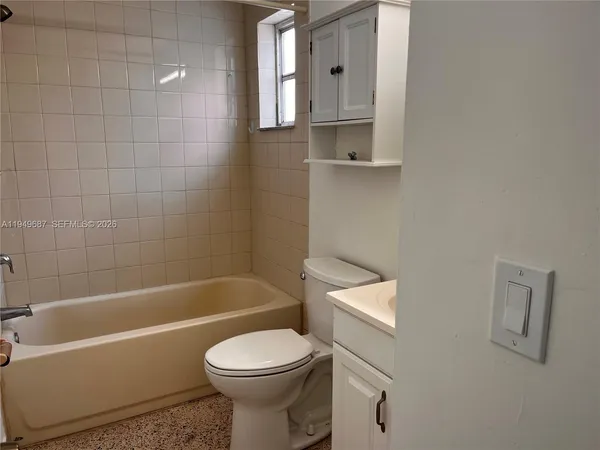 a bathroom with a toilet a sink and bathtub