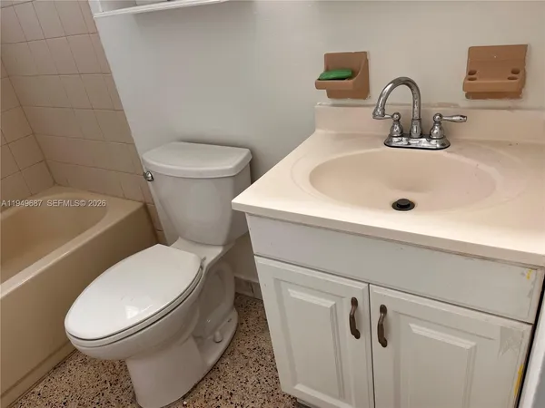 a white toilet sitting next to a bathroom sink