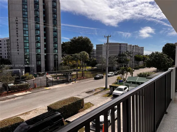 a view of a balcony with wooden floor and city view