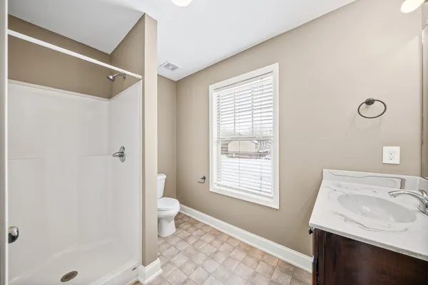 a bathroom with a sink toilet and shower