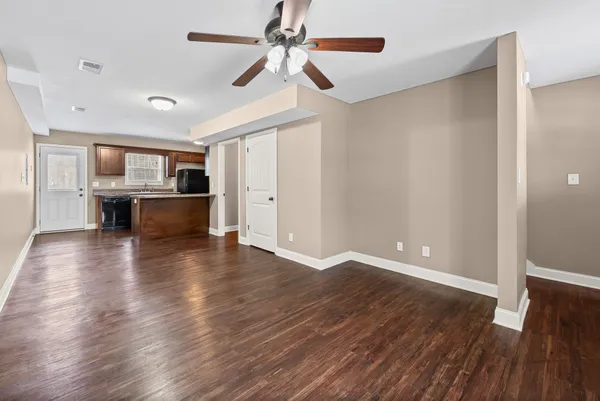 a view of kitchen with sink and refrigerator