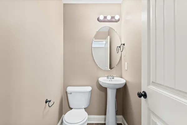 a bathroom with a toilet a sink and a mirror