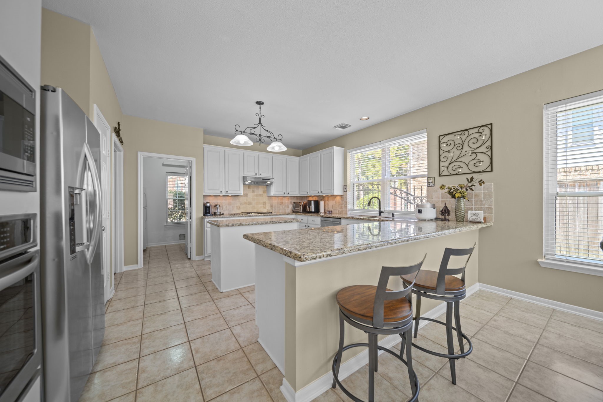 20727 Shadow Mill Court Katy, TX 77450 - Photo 15 of 48 a kitchen with stainless steel appliances granite countertop a sink and a refrigerator