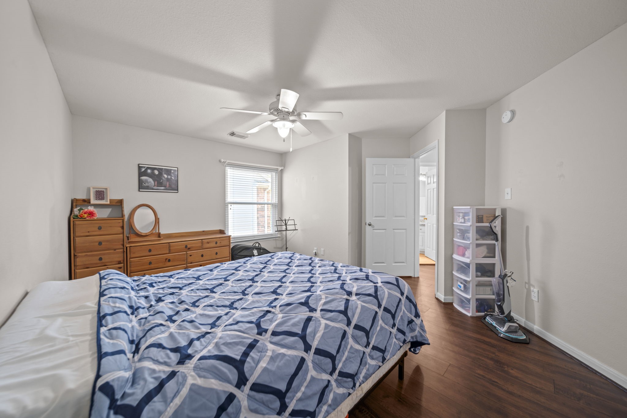 20727 Shadow Mill Court Katy, TX 77450 - Photo 30 of 48 a bedroom with a large bed and a chandelier