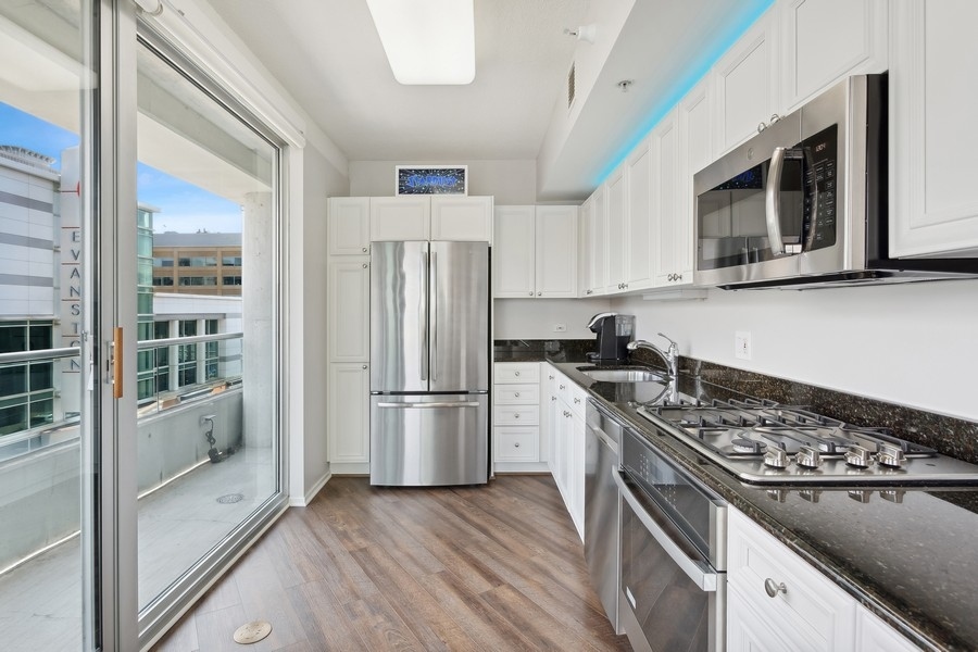 1720 Maple Avenue, Unit 405 Evanston, IL 60201 - Photo 5 of 17 a kitchen with a sink stove and refrigerator