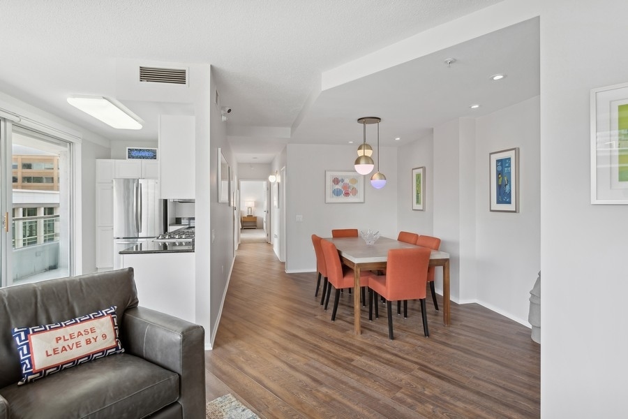 1720 Maple Avenue, Unit 405 Evanston, IL 60201 - Photo 7 of 17 a dining room with furniture and wooden floor