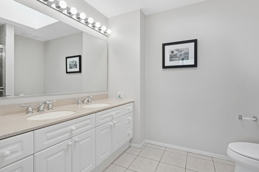 1720 Maple Avenue, Unit 405 Evanston, IL 60201 - Photo 9 of 17 a spacious bathroom with a double vanity sink and a mirror