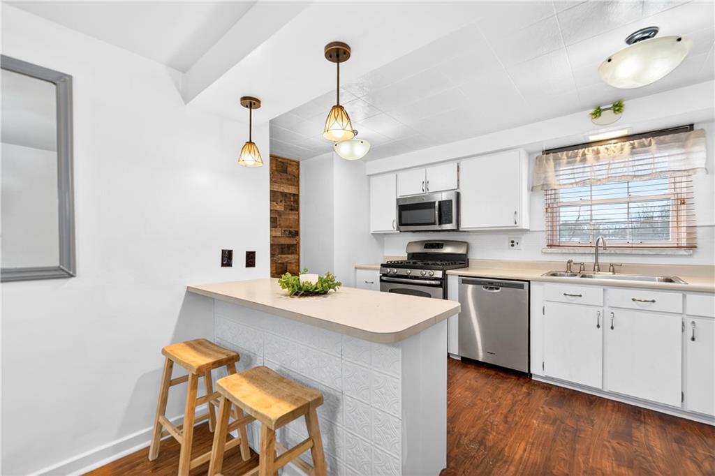 205 Hartle Road Glenshaw, PA 15116 - Photo 12 of 36 a kitchen with stainless steel appliances a sink stove and microwave
