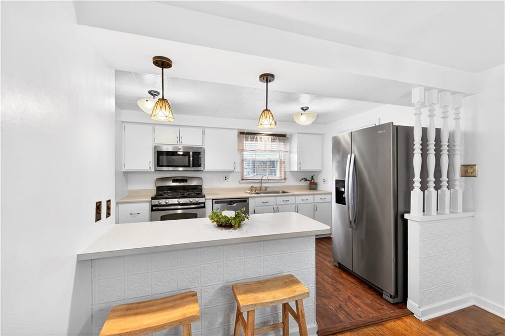 205 Hartle Road Glenshaw, PA 15116 - Photo 13 of 36 a kitchen with stainless steel appliances a dining table and chairs