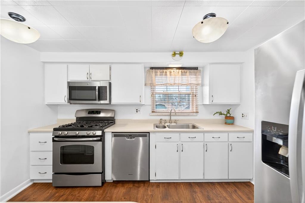 205 Hartle Road Glenshaw, PA 15116 - Photo 14 of 36 a kitchen with stainless steel appliances a stove a sink and a microwave