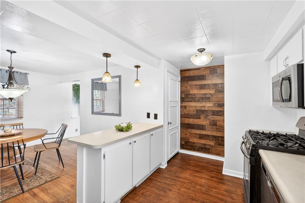 205 Hartle Road Glenshaw, PA 15116 - Photo 16 of 36 a kitchen with stainless steel appliances a stove a chandelier and a refrigerator