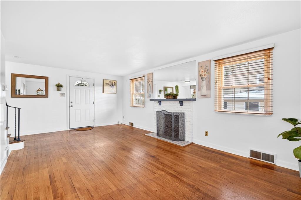 205 Hartle Road Glenshaw, PA 15116 - Photo 7 of 36 a view of a livingroom with wooden floor and a window