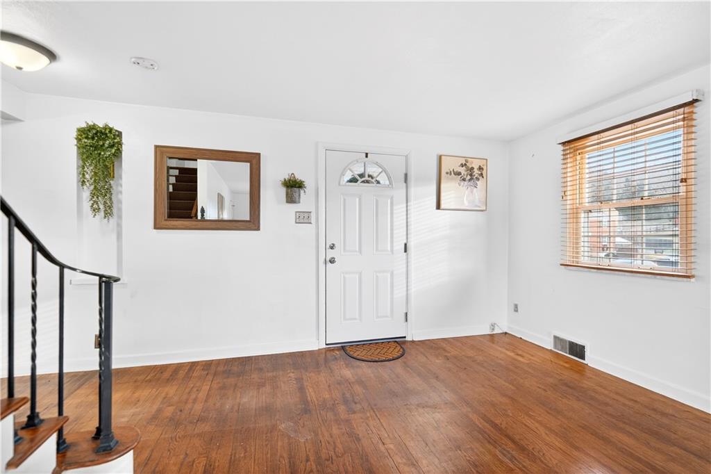 205 Hartle Road Glenshaw, PA 15116 - Photo 8 of 36 a view of a big room with wooden floor and windows