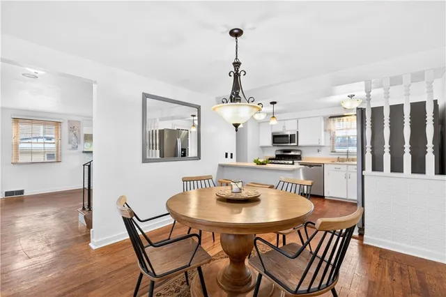 a kitchen with stainless steel appliances a sink stove and microwave