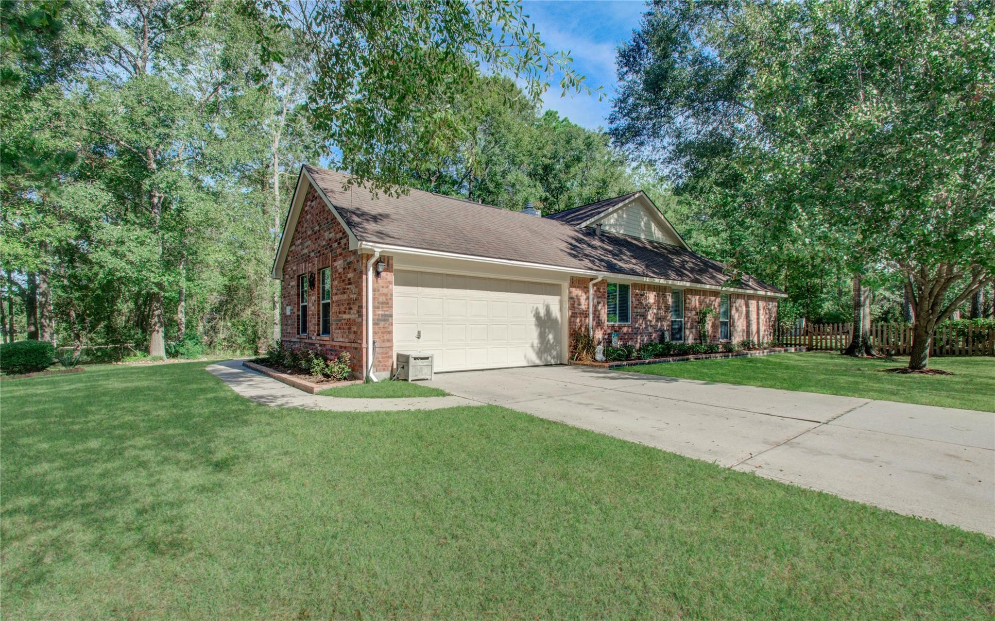 12455 West Summerlin Conroe, TX 77302 - Photo 31 of 31 a view of a house with a yard