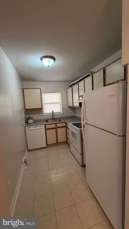 a white refrigerator freezer sitting inside of a kitchen