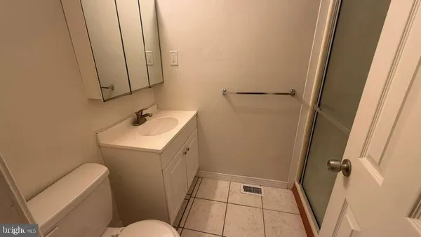 a bathroom with a sink and mirror with toilet