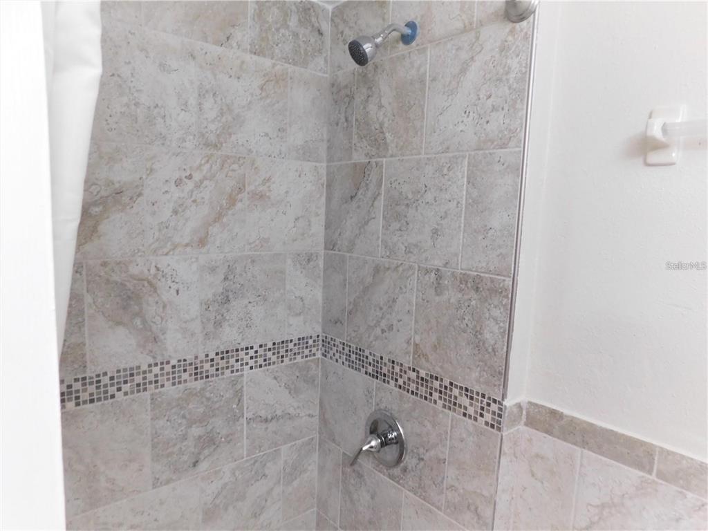21150 Gertrude Avenue, Unit B4 Port Charlotte, FL 33952 - Photo 9 of 10 a bathroom with a shower