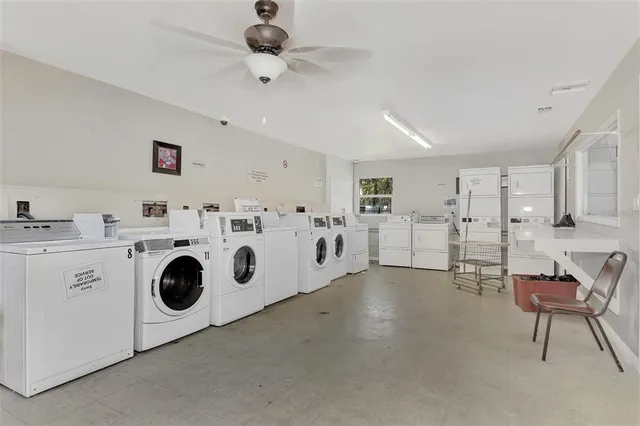 a utility room with multiple dryer and washer