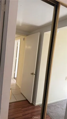 a view of walk in closet with wooden floor