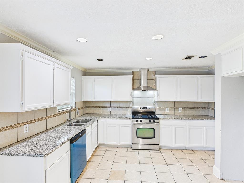 6909 Valhalla Road Fort Worth, TX 76116 - Photo 4 of 15 a kitchen with a stove sink cabinets and front door