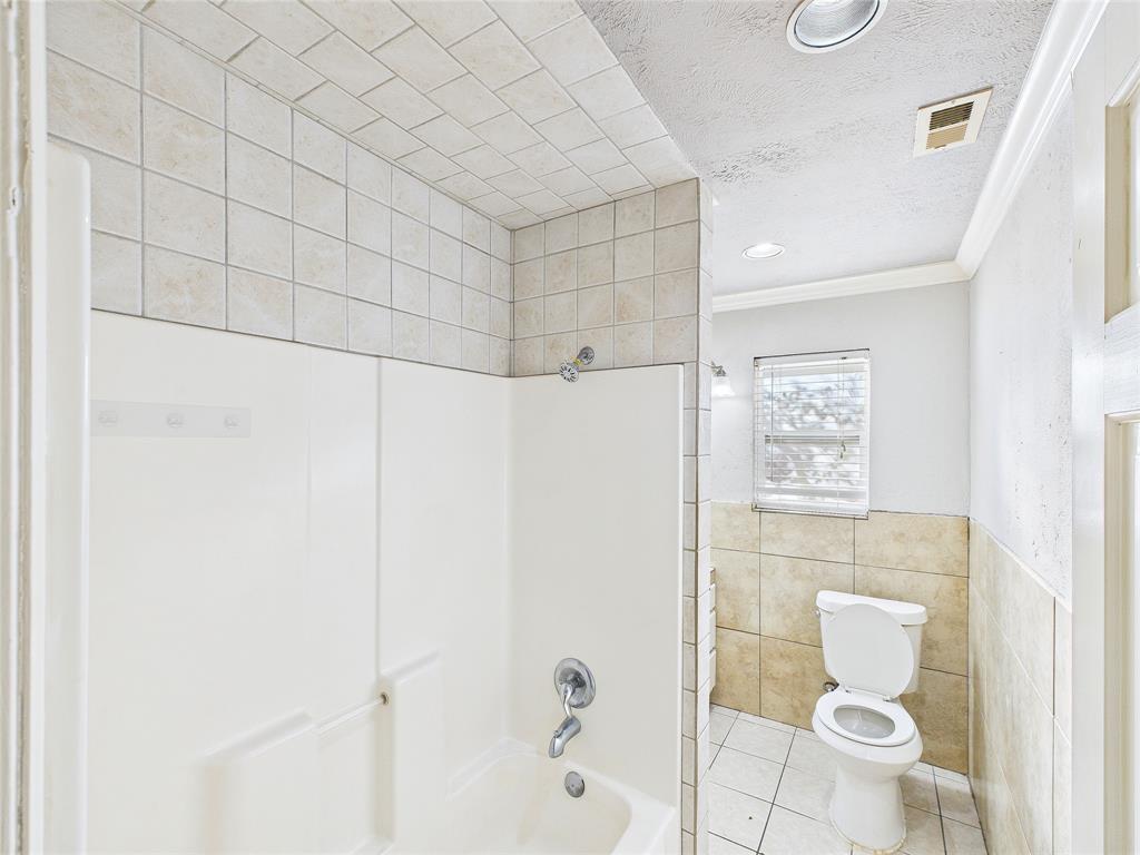 6909 Valhalla Road Fort Worth, TX 76116 - Photo 8 of 15 a bathroom with a toilet and a shower