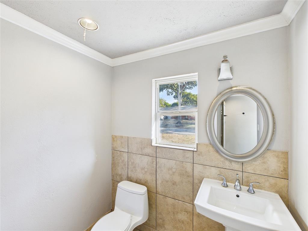 6909 Valhalla Road Fort Worth, TX 76116 - Photo 9 of 15 a bathroom with a sink mirror and toilet