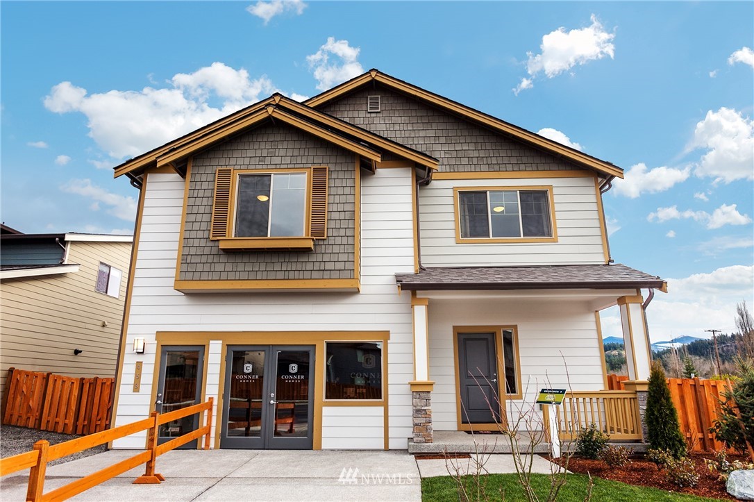 443 Partlon Street, Unit 75 Buckley, WA 98321 - Photo 1 of 25 a front view of a house with a yard
