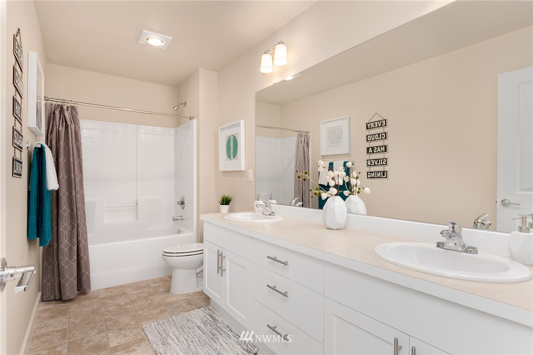 443 Partlon Street, Unit 75 Buckley, WA 98321 - Photo 17 of 25 a bathroom with a double vanity sink toilet mirror and shower