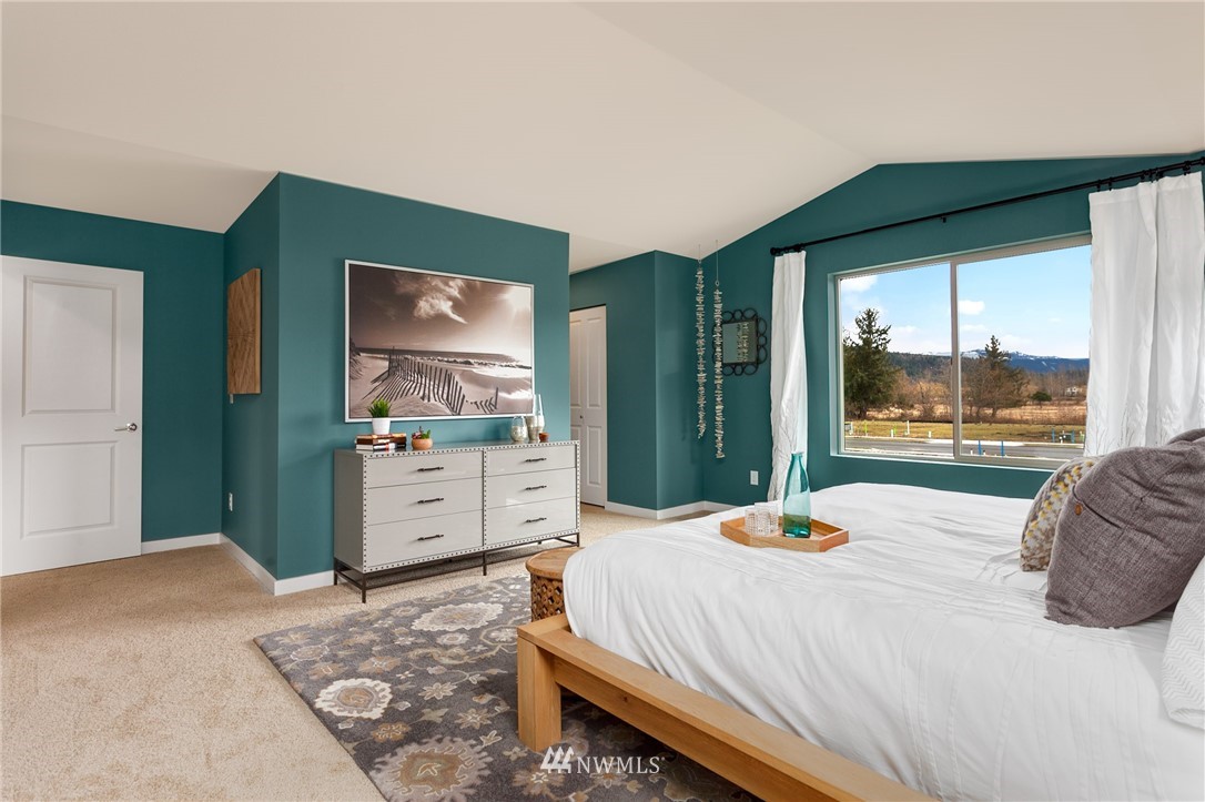 443 Partlon Street, Unit 75 Buckley, WA 98321 - Photo 19 of 25 a bedroom with a bed and a large window