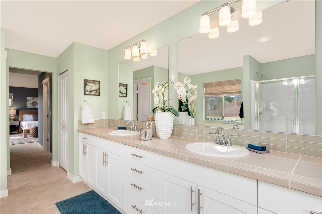 443 Partlon Street, Unit 75 Buckley, WA 98321 - Photo 20 of 25 a en suite bathroom with double sink and a mirror