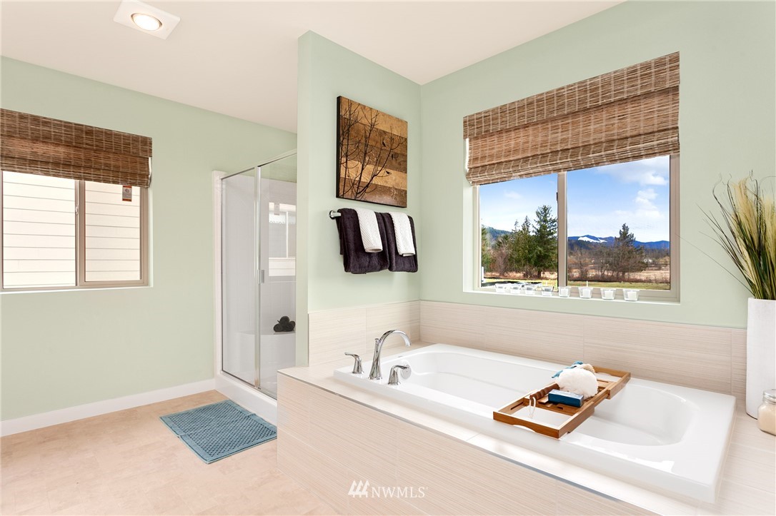443 Partlon Street, Unit 75 Buckley, WA 98321 - Photo 21 of 25 a white bed sitting in a bathroom next to a window