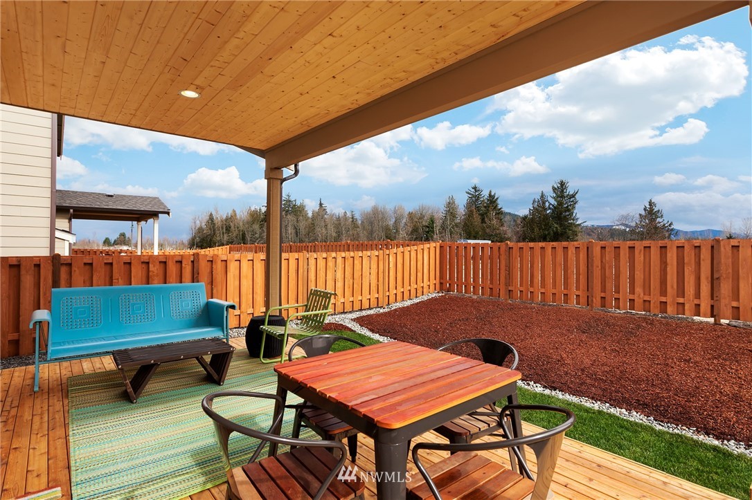 443 Partlon Street, Unit 75 Buckley, WA 98321 - Photo 22 of 25 a backyard of a house with table and chairs
