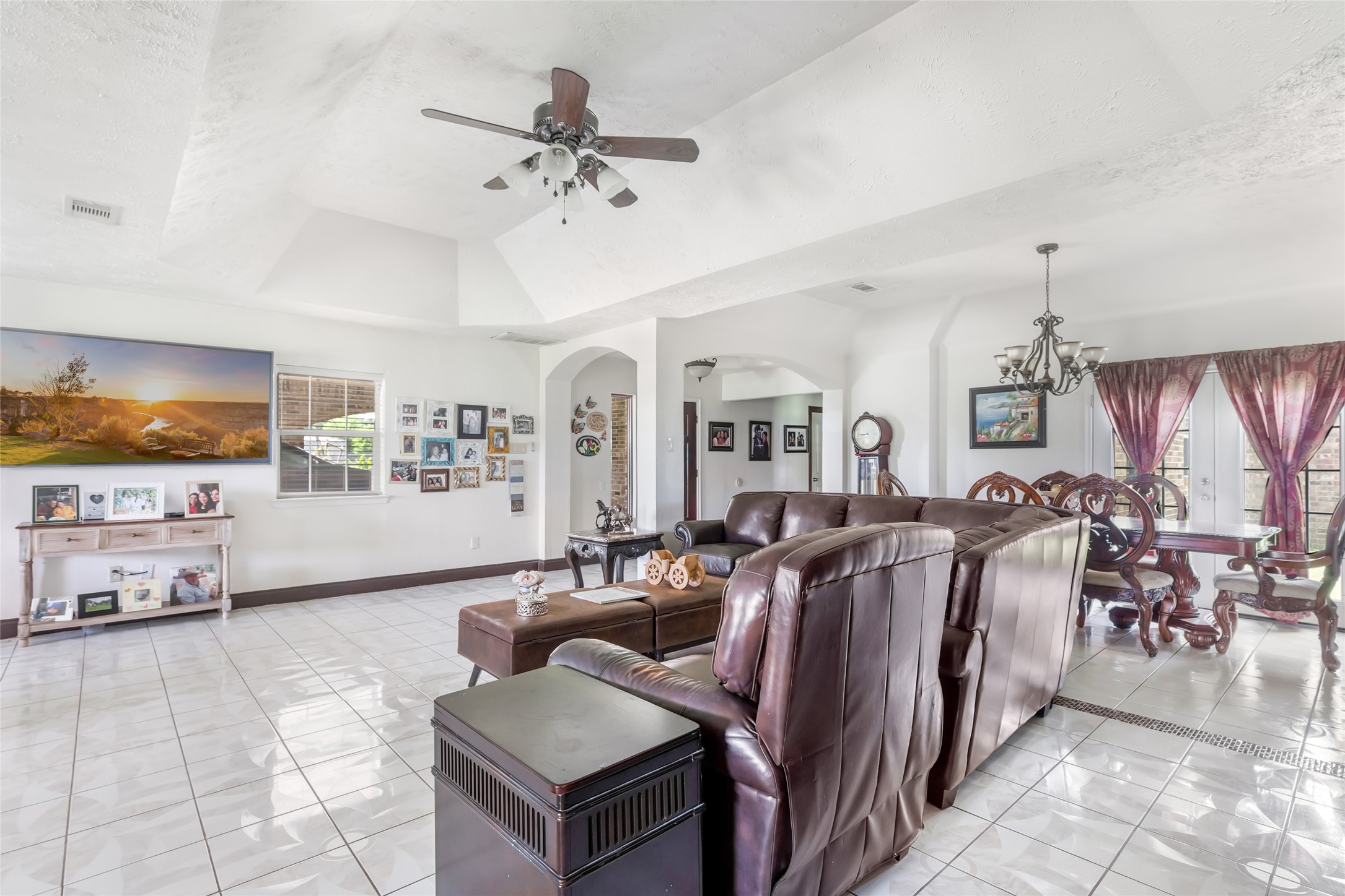 15123 Lindstrom Road Crosby, TX 77532 - Photo 13 of 39 Generous living room anchored by beautiful details and designed for comfort, with a natural flow into one of the two dining spaces, making it ideal for both casual and formal occasions.