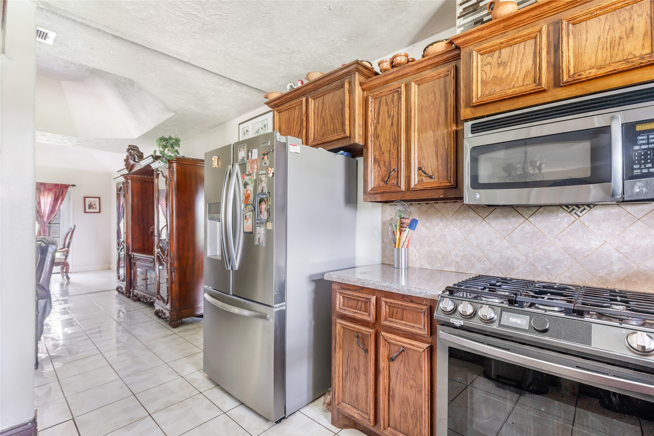 15123 Lindstrom Road Crosby, TX 77532 - Photo 18 of 39 a kitchen with stainless steel appliances granite countertop a refrigerator stove and microwave