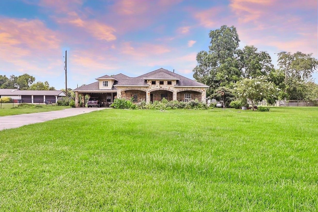 15123 Lindstrom Road Crosby, TX 77532 - Photo 2 of 39 This impressive home showcases a striking brick and stone exterior that combines timeless charm with enduring quality.