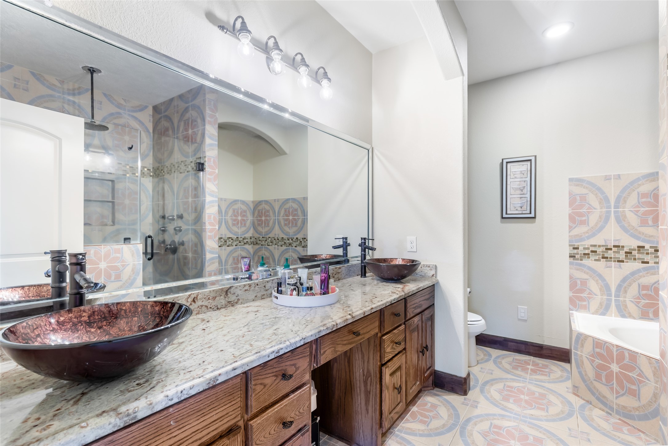 15123 Lindstrom Road Crosby, TX 77532 - Photo 22 of 39 a bathroom with a granite countertop sink a mirror and a shower