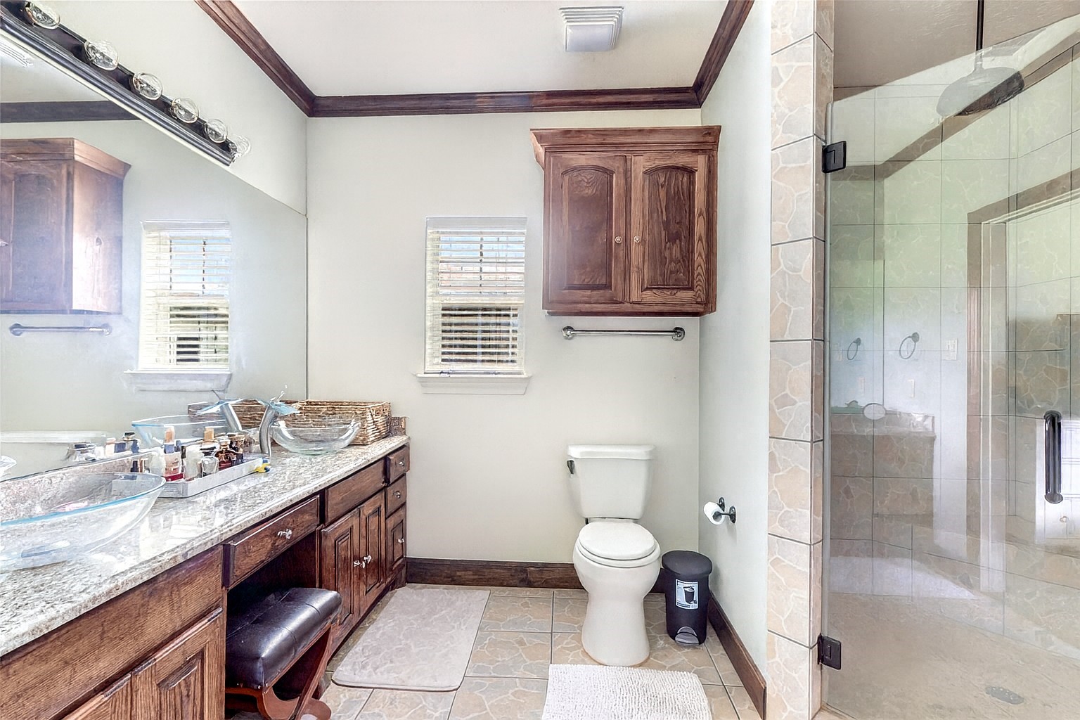 15123 Lindstrom Road Crosby, TX 77532 - Photo 29 of 39 This secondary bathroom is both stylish and functional, offering a walk-in shower with a glass door and an overhead rain shower head for a spa-like experience.