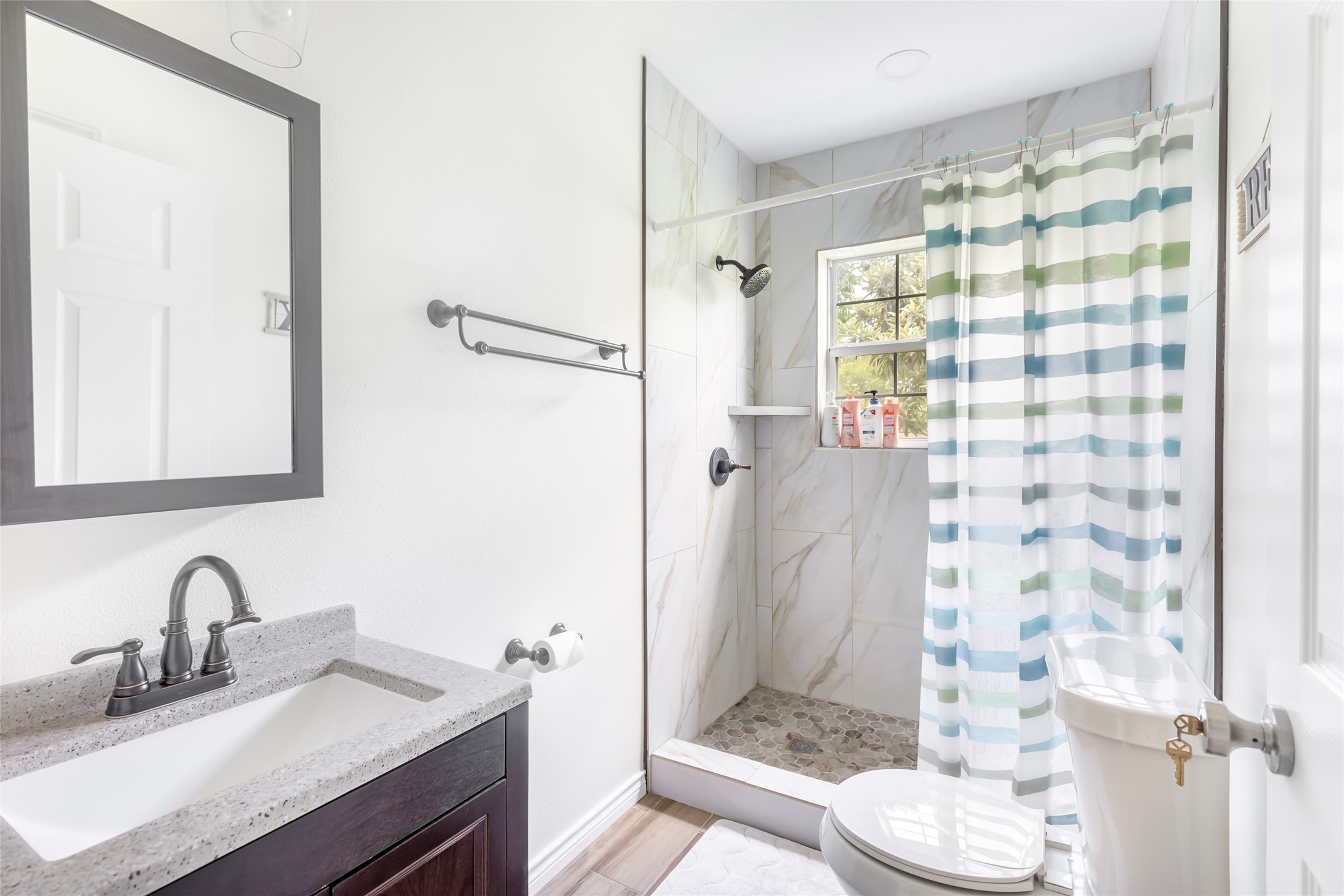 15123 Lindstrom Road Crosby, TX 77532 - Photo 31 of 39 a bathroom with a granite countertop sink toilet and shower