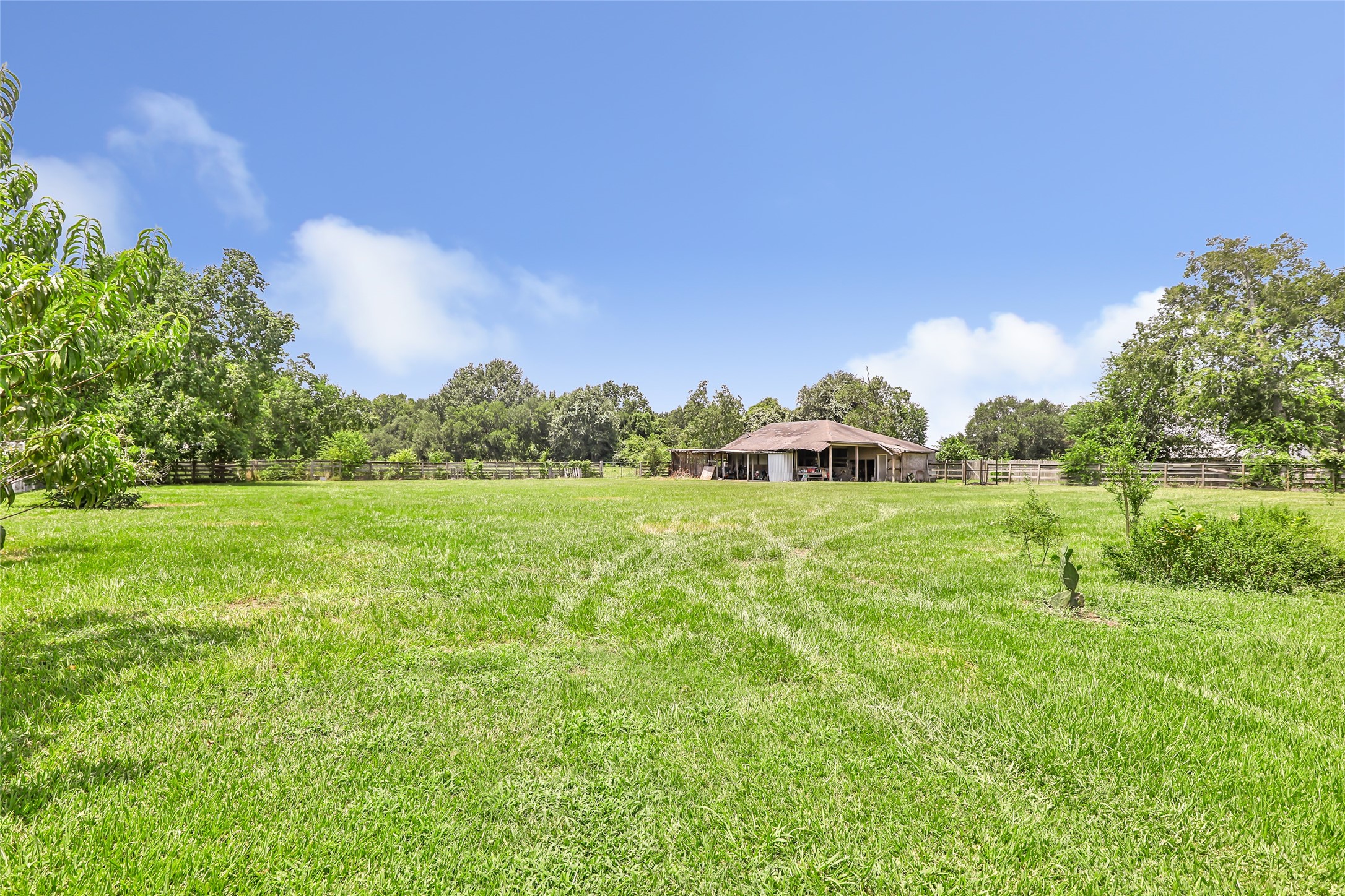 15123 Lindstrom Road Crosby, TX 77532 - Photo 5 of 39 a view of a green field with wooden fence