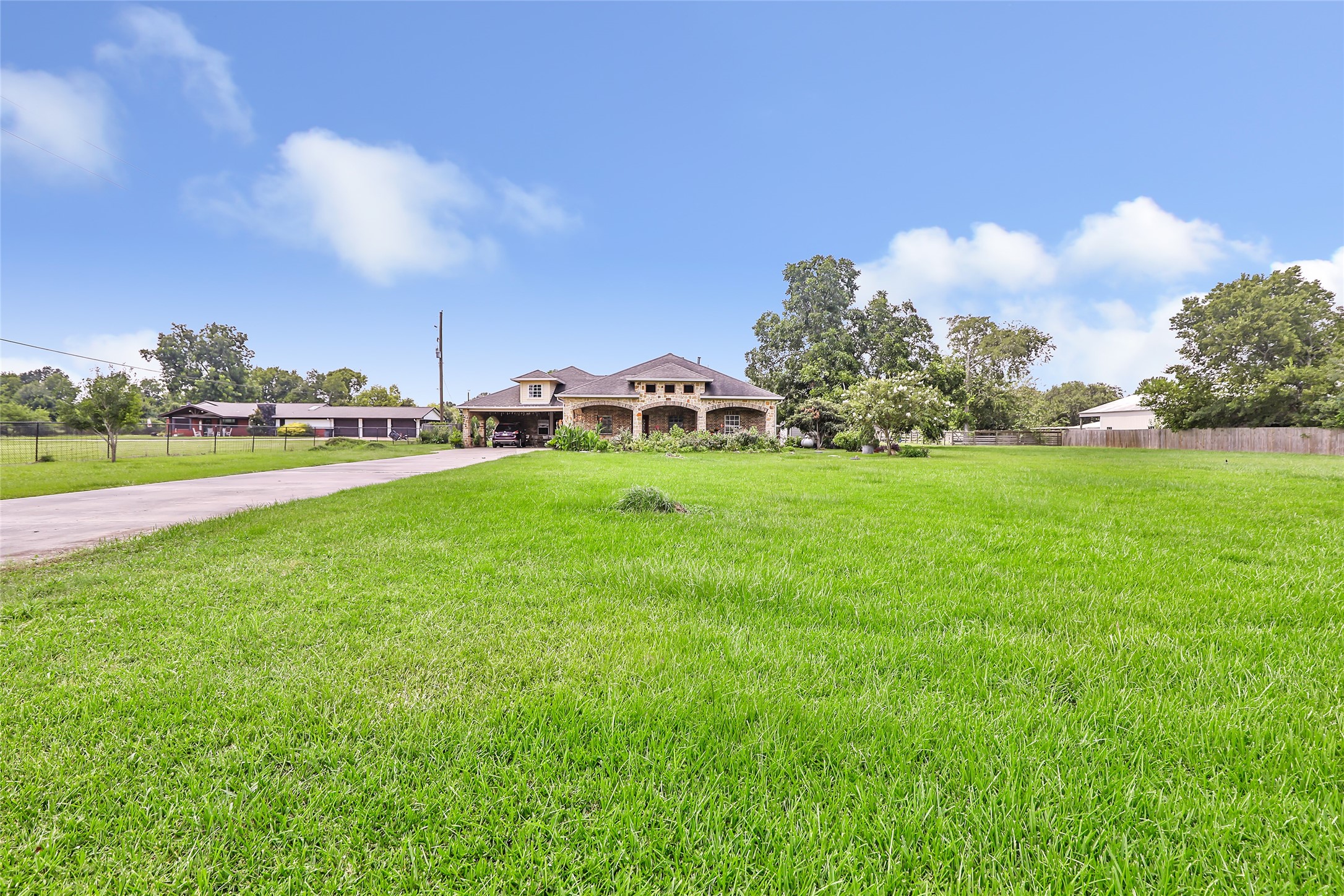 15123 Lindstrom Road Crosby, TX 77532 - Photo 8 of 39 a view of a house with a big yard and palm trees