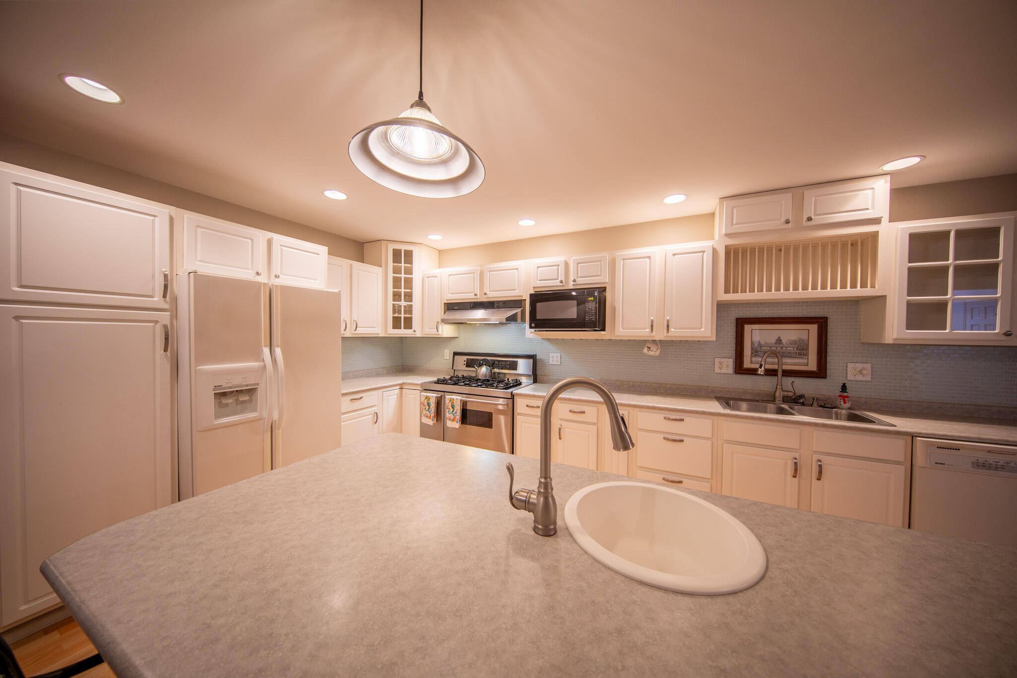 107 Center Street Michigan City, IN 46360 - Photo 17 of 67 a kitchen with refrigerator cabinets and a sink