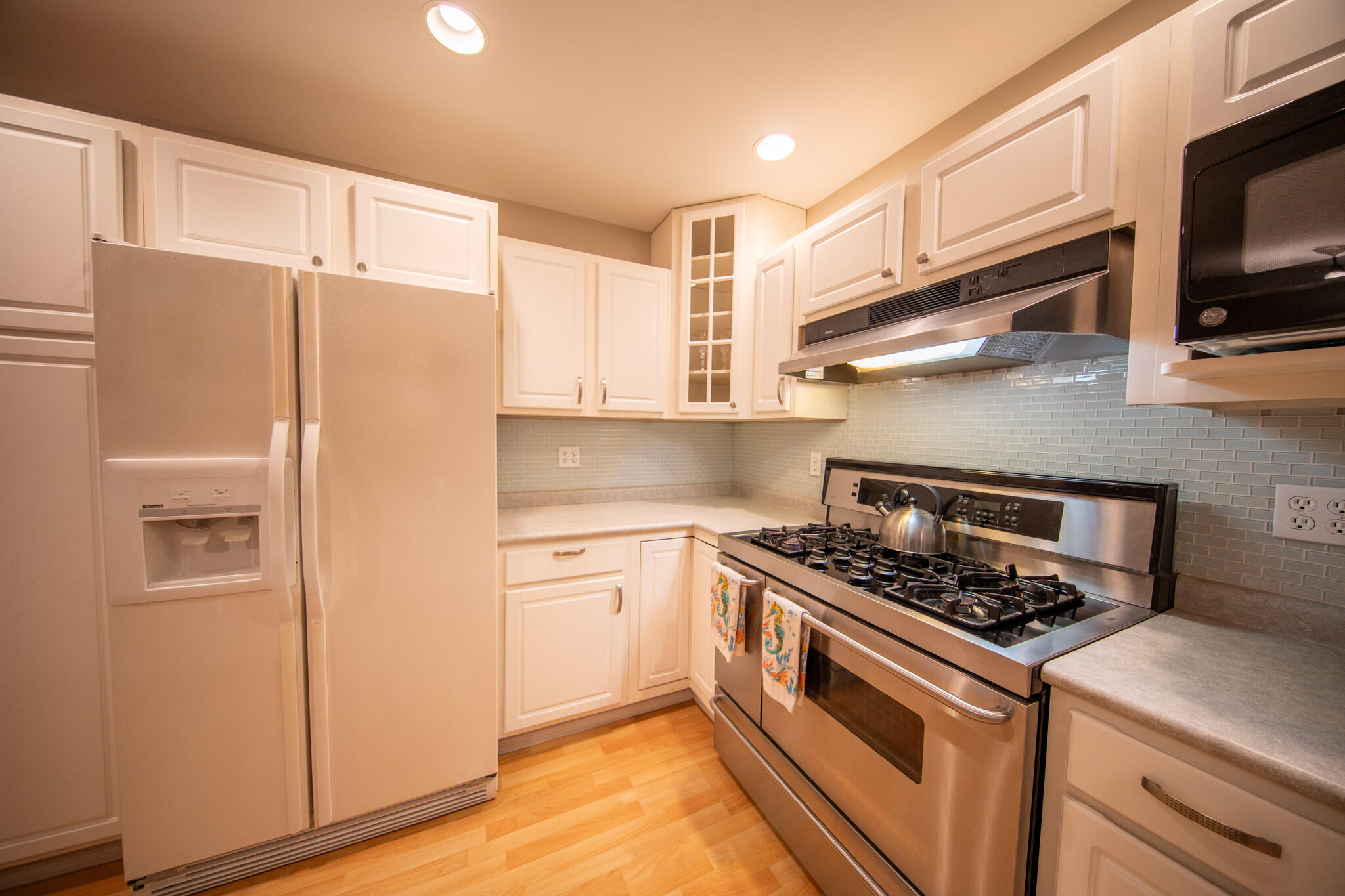 107 Center Street Michigan City, IN 46360 - Photo 18 of 67 a kitchen with stainless steel appliances granite countertop cabinets and a stove top oven