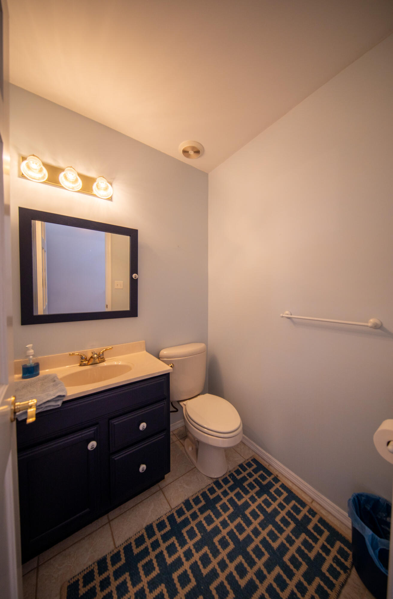 107 Center Street Michigan City, IN 46360 - Photo 30 of 67 a bathroom with a toilet a sink and a mirror
