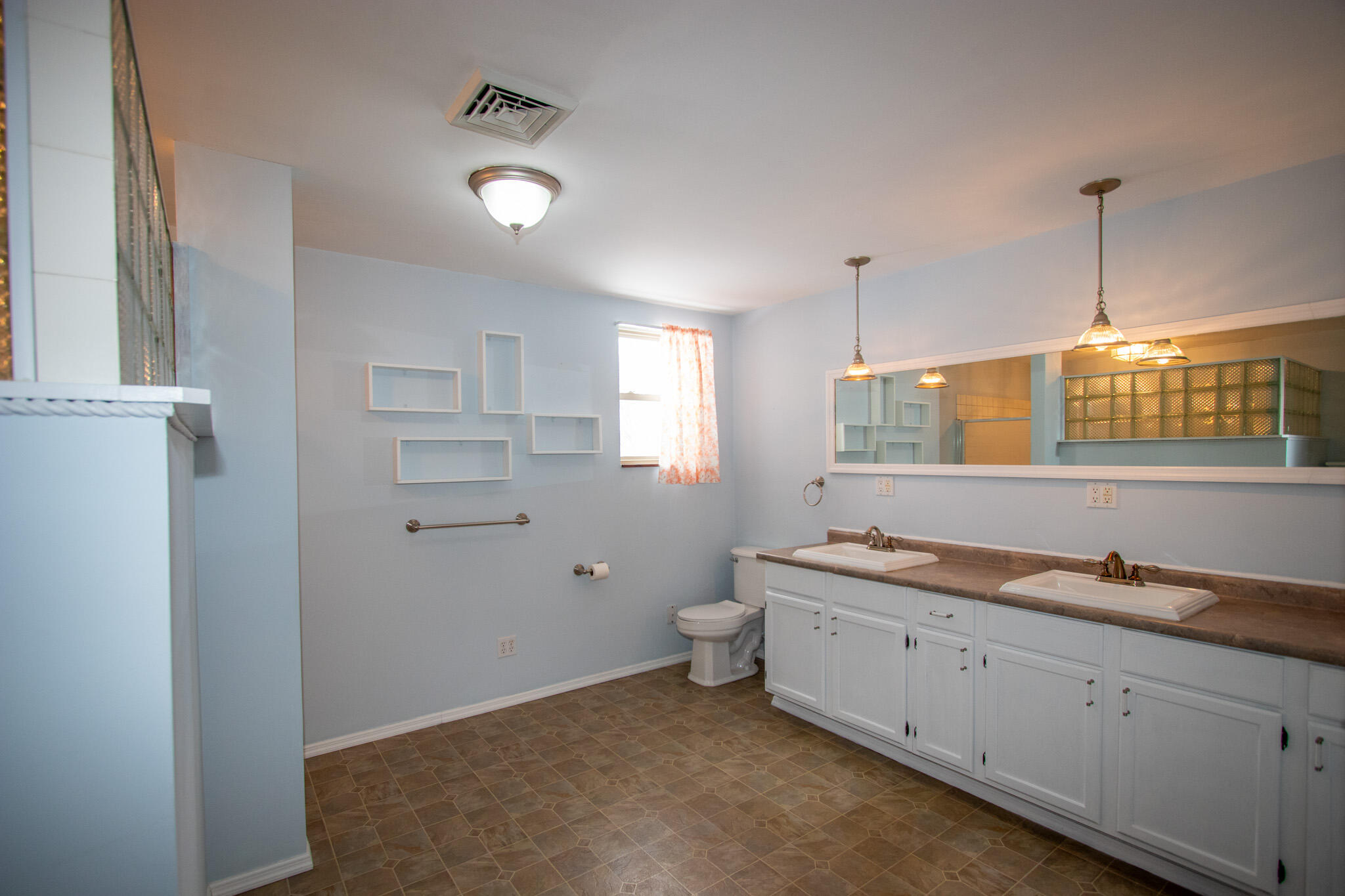 107 Center Street Michigan City, IN 46360 - Photo 39 of 67 a spacious bathroom with a granite countertop sink mirror and toilet