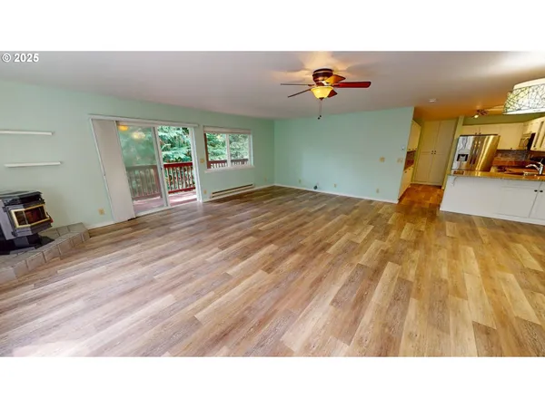 a kitchen with a window and wooden floor