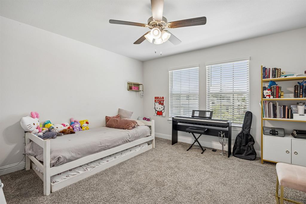 425 Breeds Hl Road Little Elm, TX 75068 - Photo 26 of 38 a bedroom with furniture and a book shelf