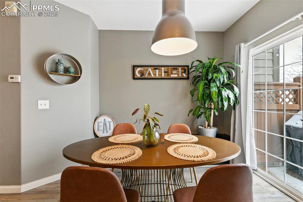 997 Burning Bush Point Monument, CO 80132 - Photo 11 of 34 a view of a dining room with furniture and wooden floor